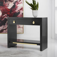 Black nightstand in styled room with plant on top.