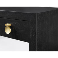 Close-up of black nightstand's gold drawer handle.