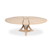 Jupe dining table with extension leaves partially open.