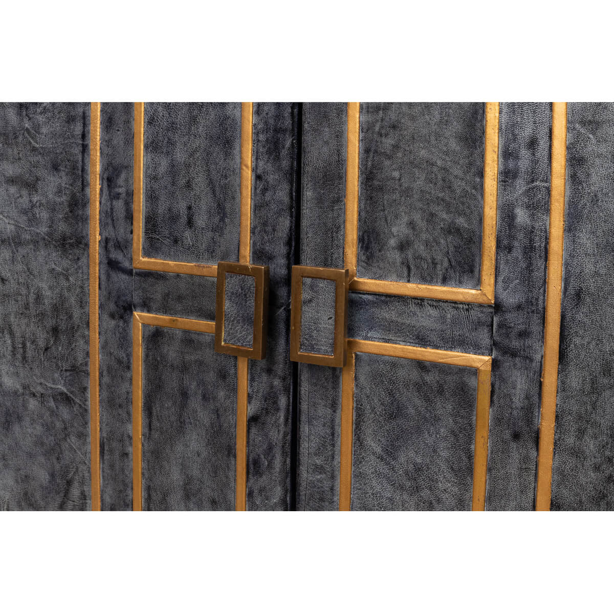 Close-up of cabinet doors, leather texture and handles.