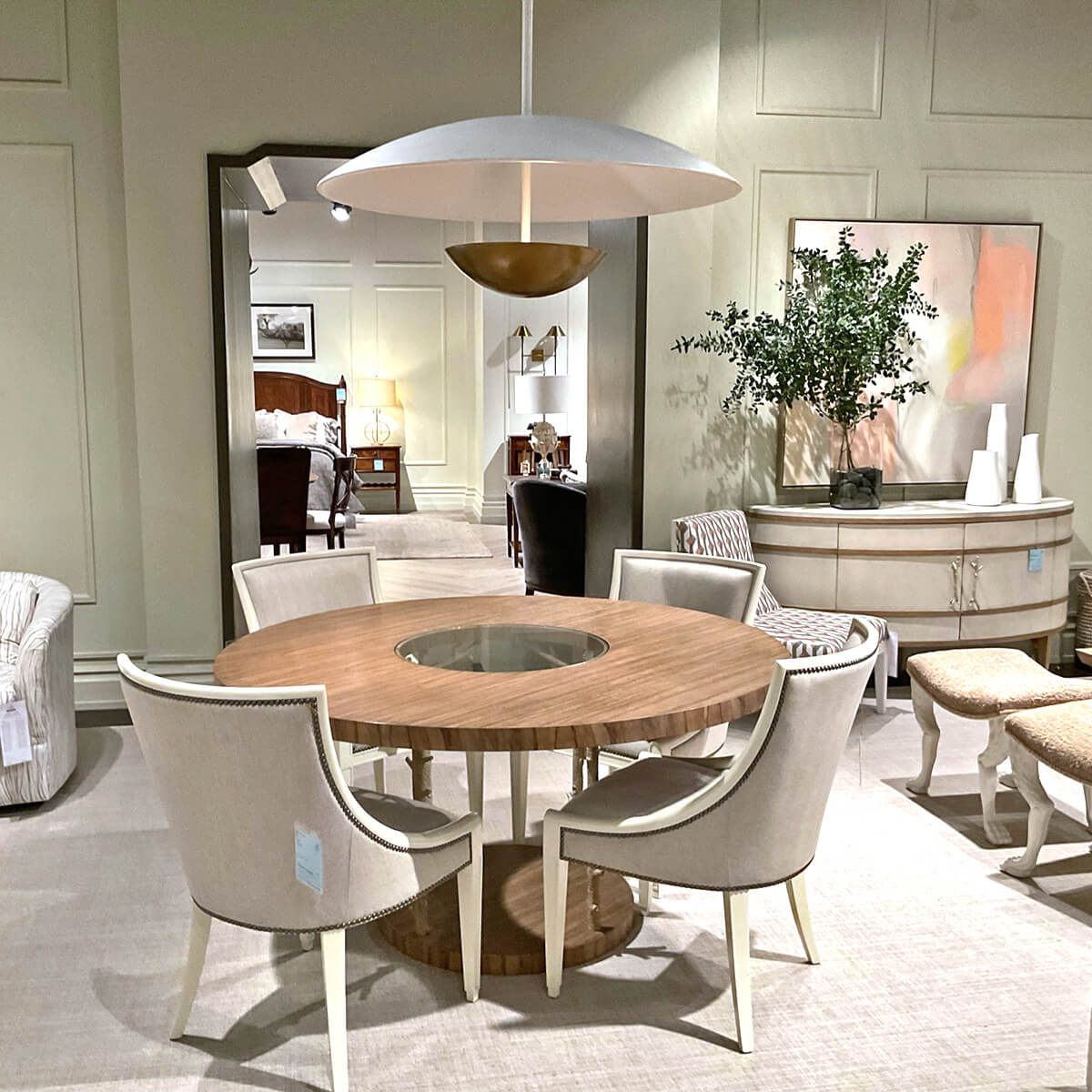 Modern Bowl Chandelier, highlighting elegant showroom dining setup.
