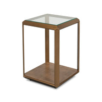 Side view of glass-top accent table with brass frame.