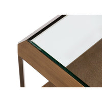 Close-up of coffee table corner, brass and glass.