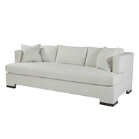 Modern white upholstered sofa with pillows, angled view
