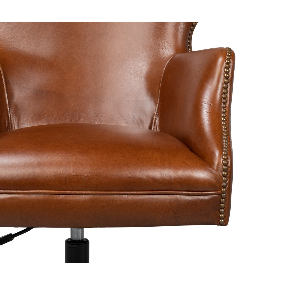 Brown leather desk chair seat and armrest detail
