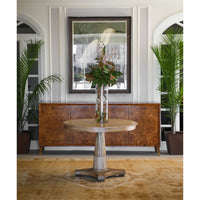 Burl sideboard behind a round table in a stylish room.