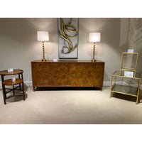 Burl sideboard surrounded by decor in a showroom setting.