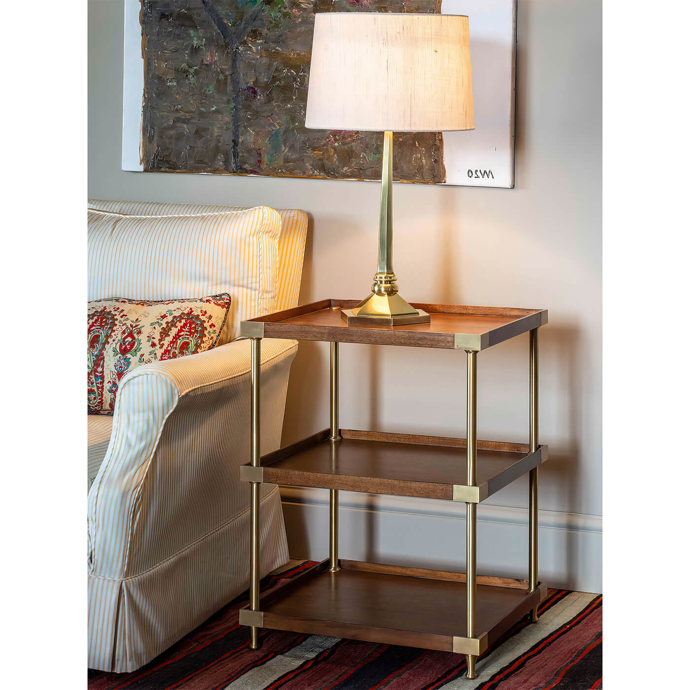 Etagere side table with lamp, sofa setting.