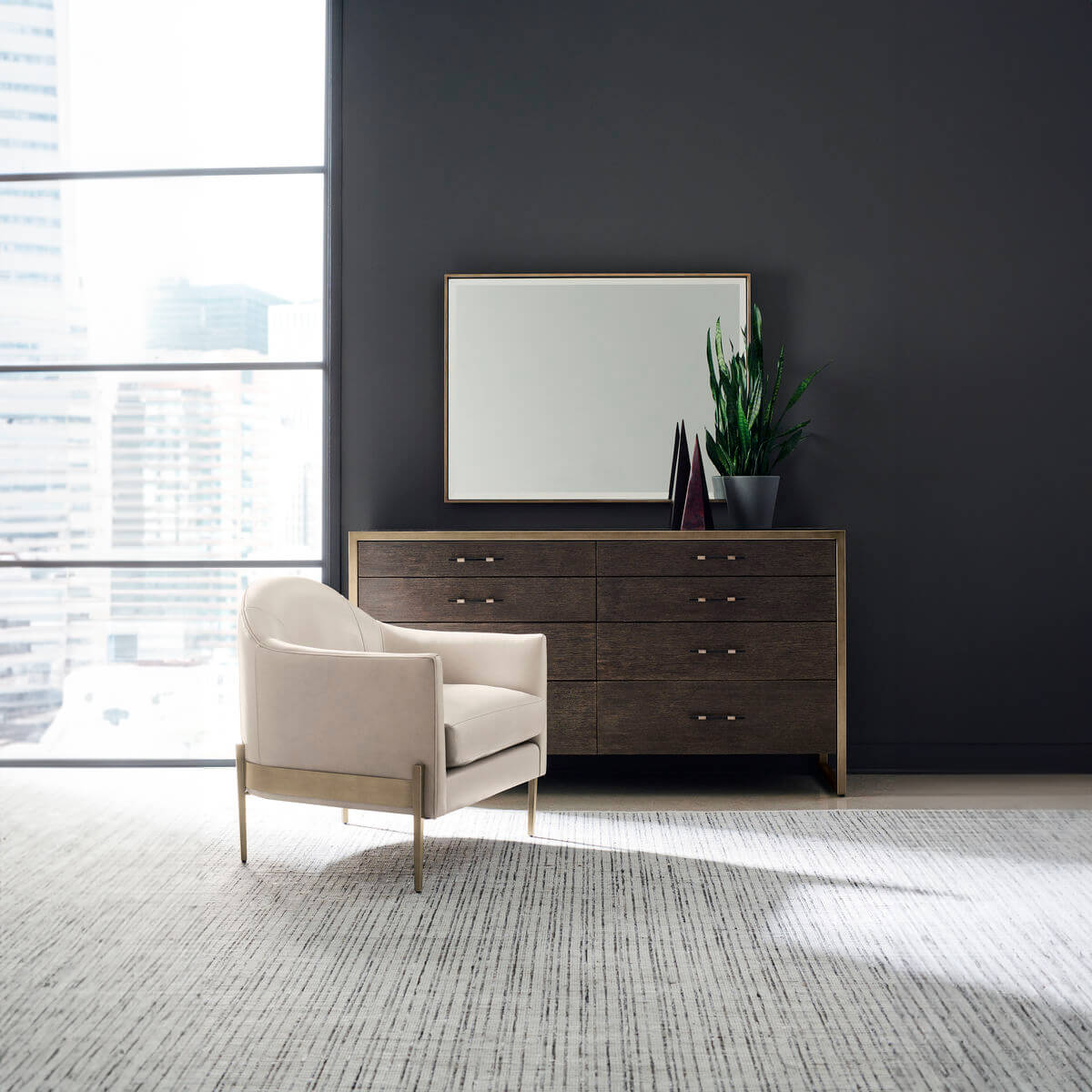Modern double dresser staged with chair and decor.