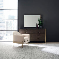 Modern double dresser staged with chair and decor.