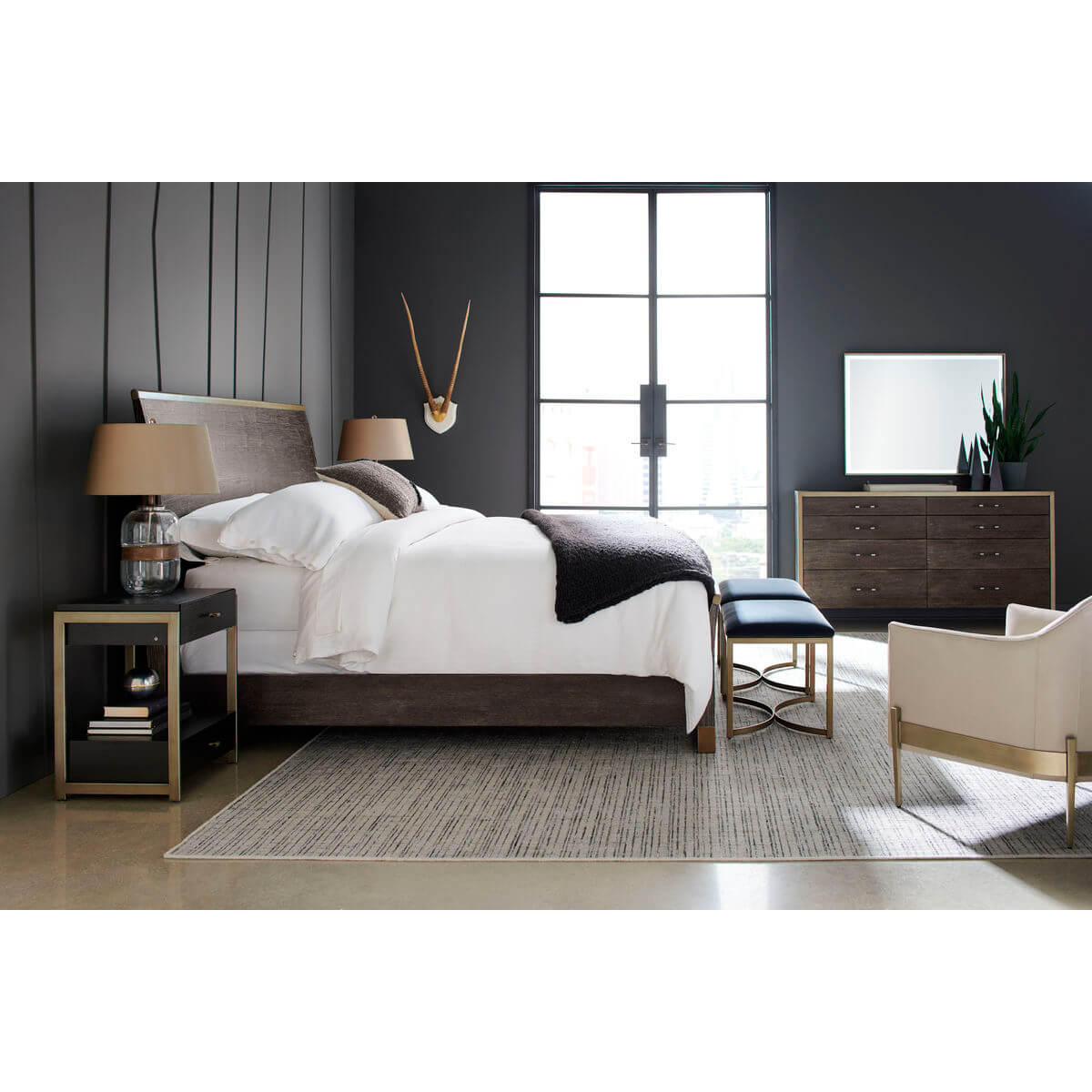 Bedroom featuring modern double dresser and decor items.