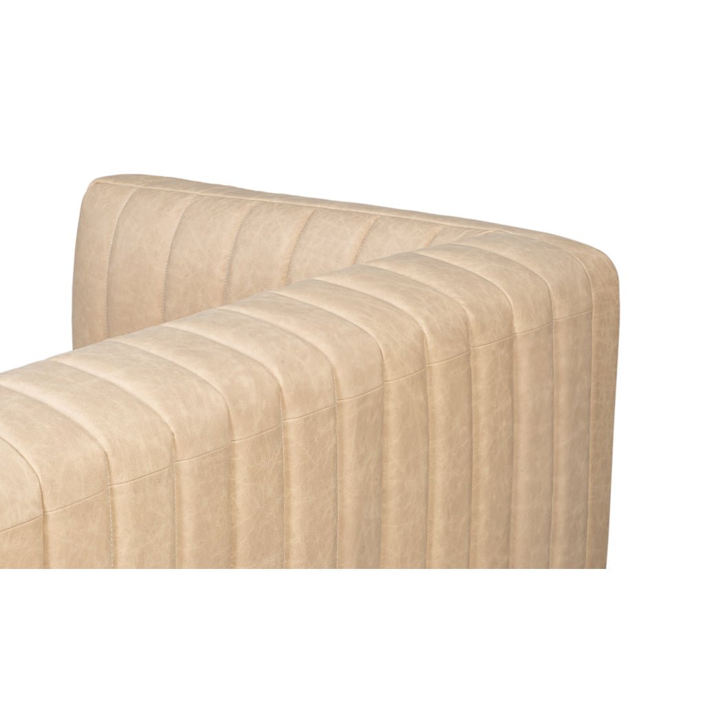 Top angle showing tufted back of leather sofa.