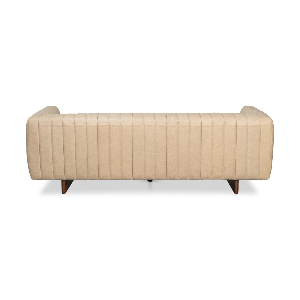 Rear view of modern white leather tufted sofa.