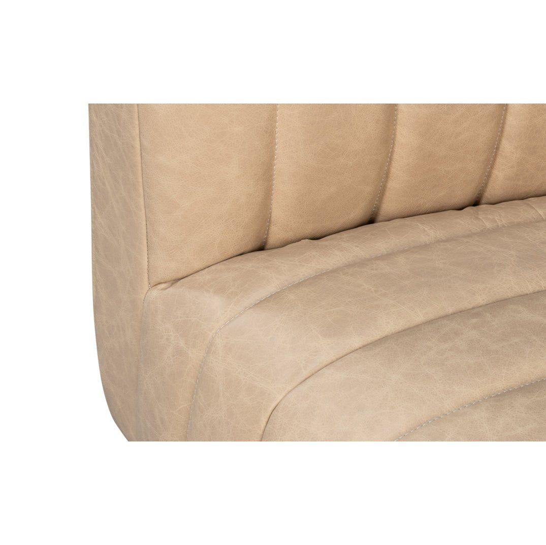 Detailed shot of leather texture on modern sofa seat.