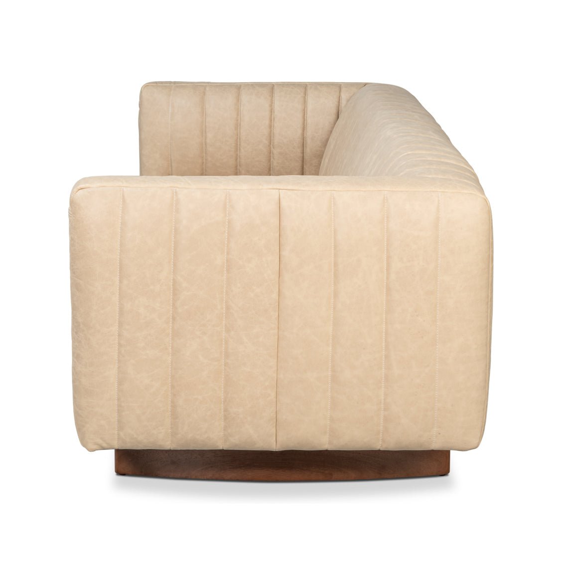 Side view of modern tufted white leather sofa.