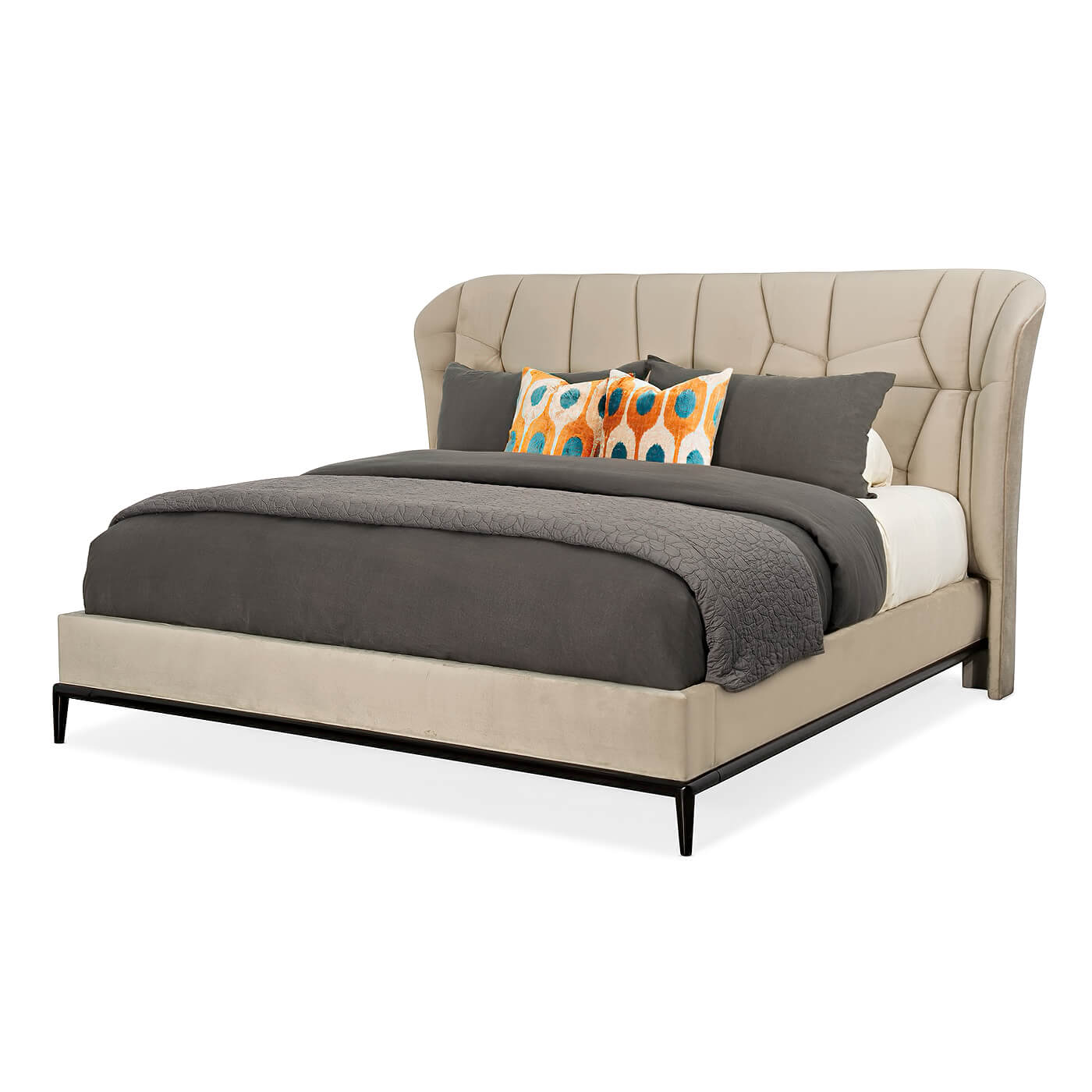 Beige upholstered king bed with geometric headboard and pillows.