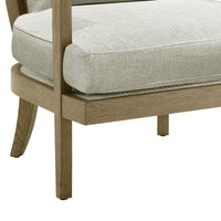 Detail of armchair seat and wooden legs.