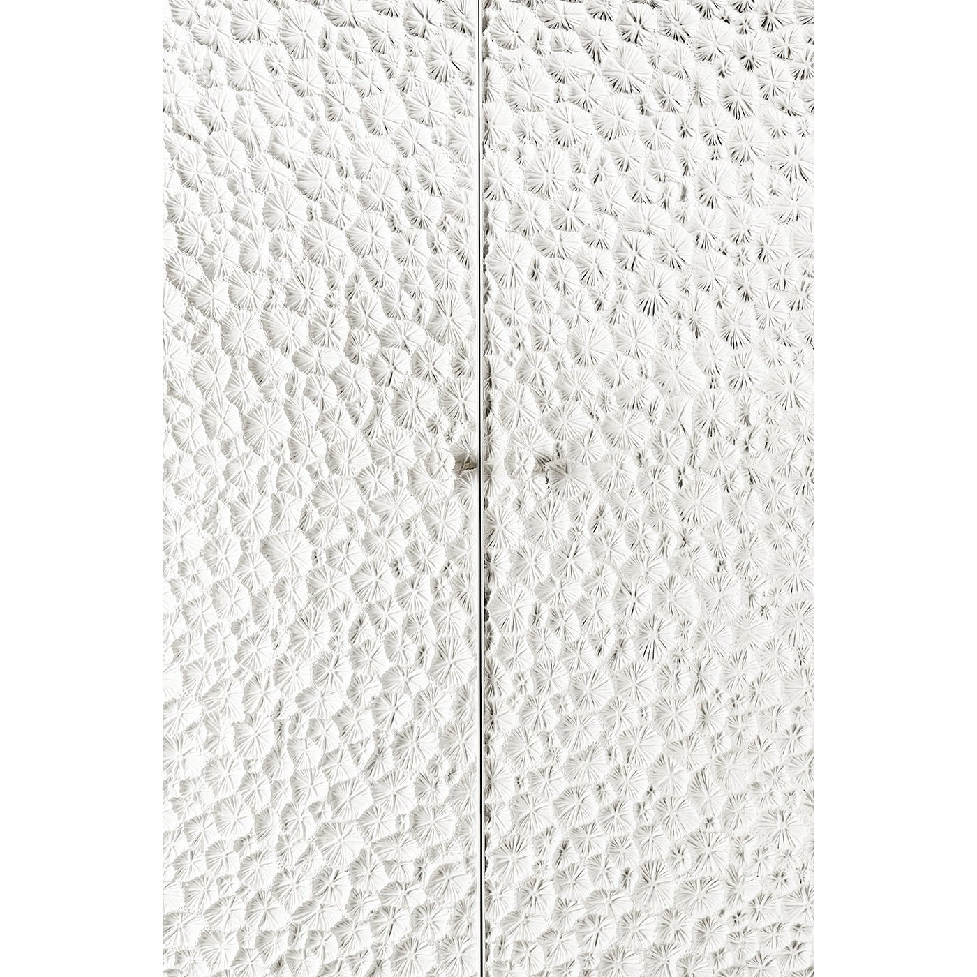 Close-up of textured cabinet doors with handles.