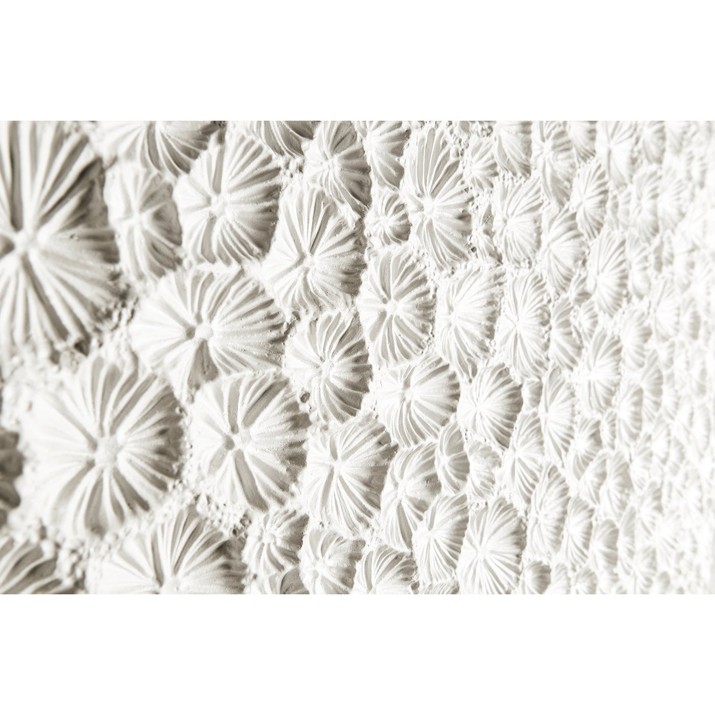 Close-up of intricate white textured cabinet surface.