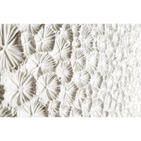 Close-up of intricate white textured cabinet surface.
