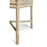 Coastal dining chair leg showing natural wood texture.