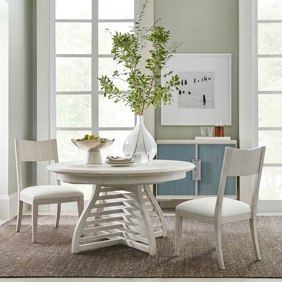 Dining table in modern room setting with chairs.