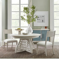 Dining table in modern room setting with chairs.