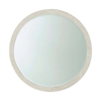 Round mirror with wood frame, modern coastal design.