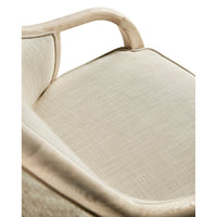 Close-up of armchair seat cushion detail and armrest.