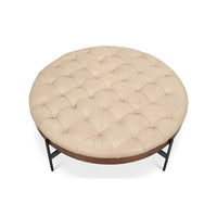 Top view of tufted round cocktail ottoman surface.