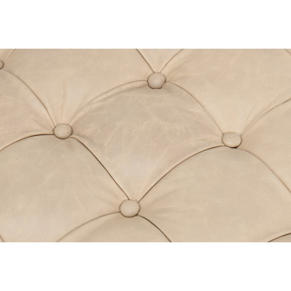 Close-up of ottoman's detailed tufted buttons.