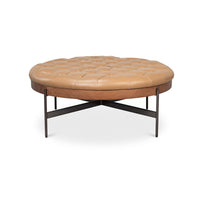 Round caramel leather ottoman front view.
