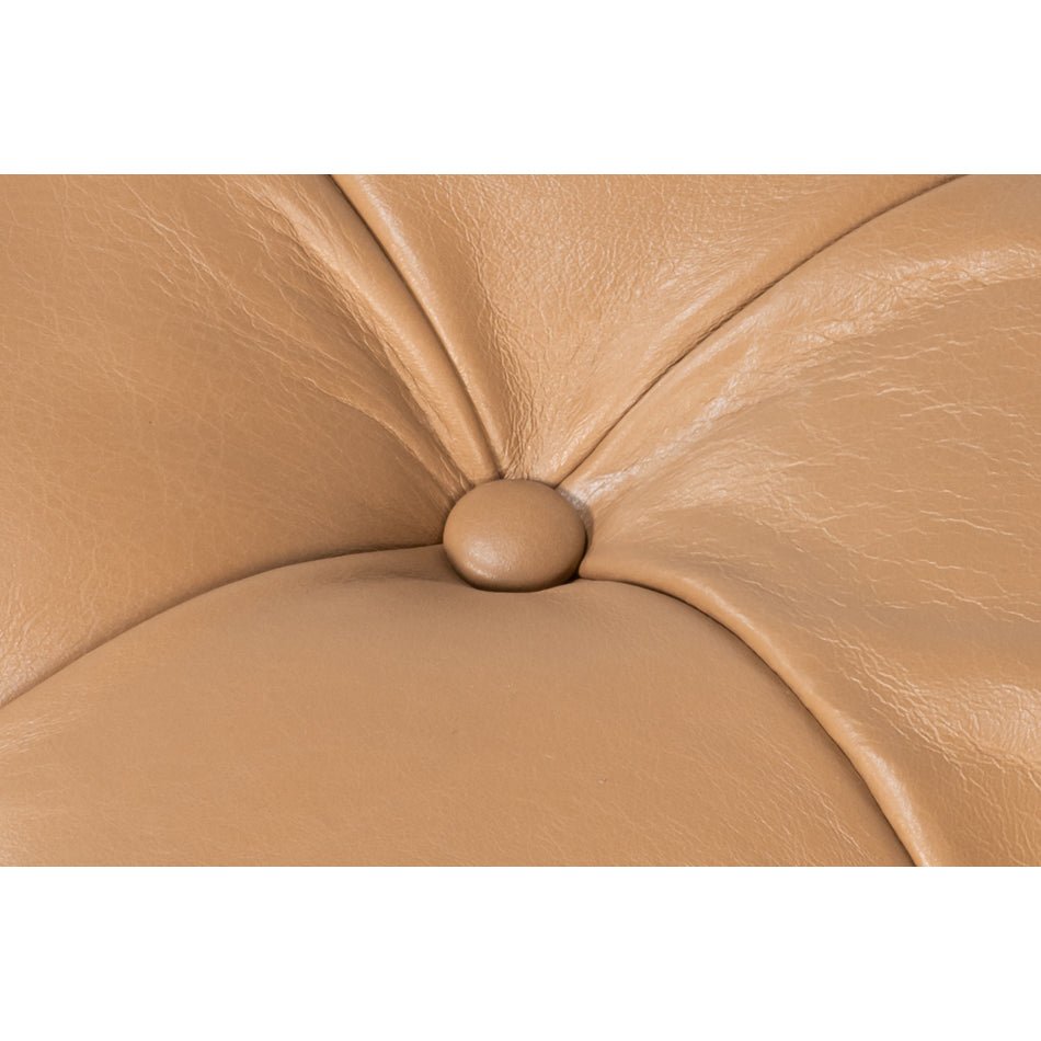 Detail of button-tufted leather on ottoman.