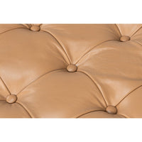 Close-up of caramel leather tufting details.