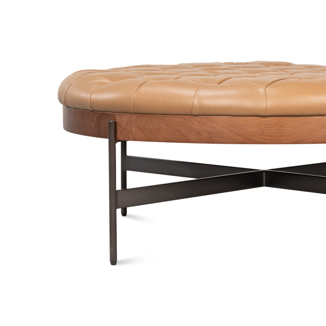 X-shaped metal base of caramel ottoman.