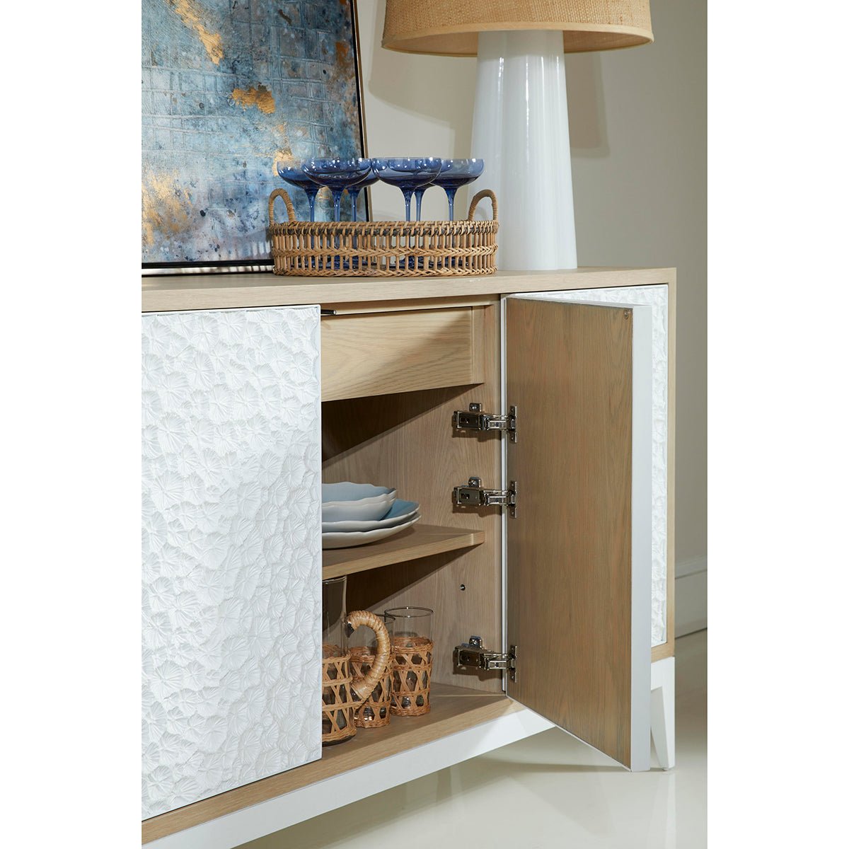 Open door view showing sideboard's shelving with dishes.