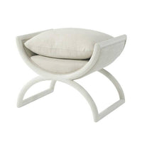 Light fabric modern curule stool, angled view with cushion.