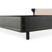 Corner detail of modern dark oak bed frame.
