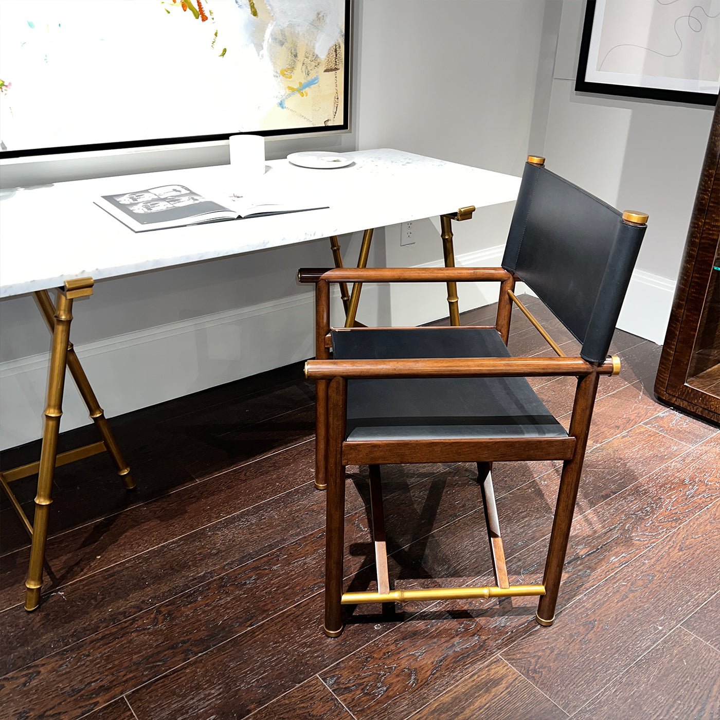 Modern director's desk chair next to a white desk