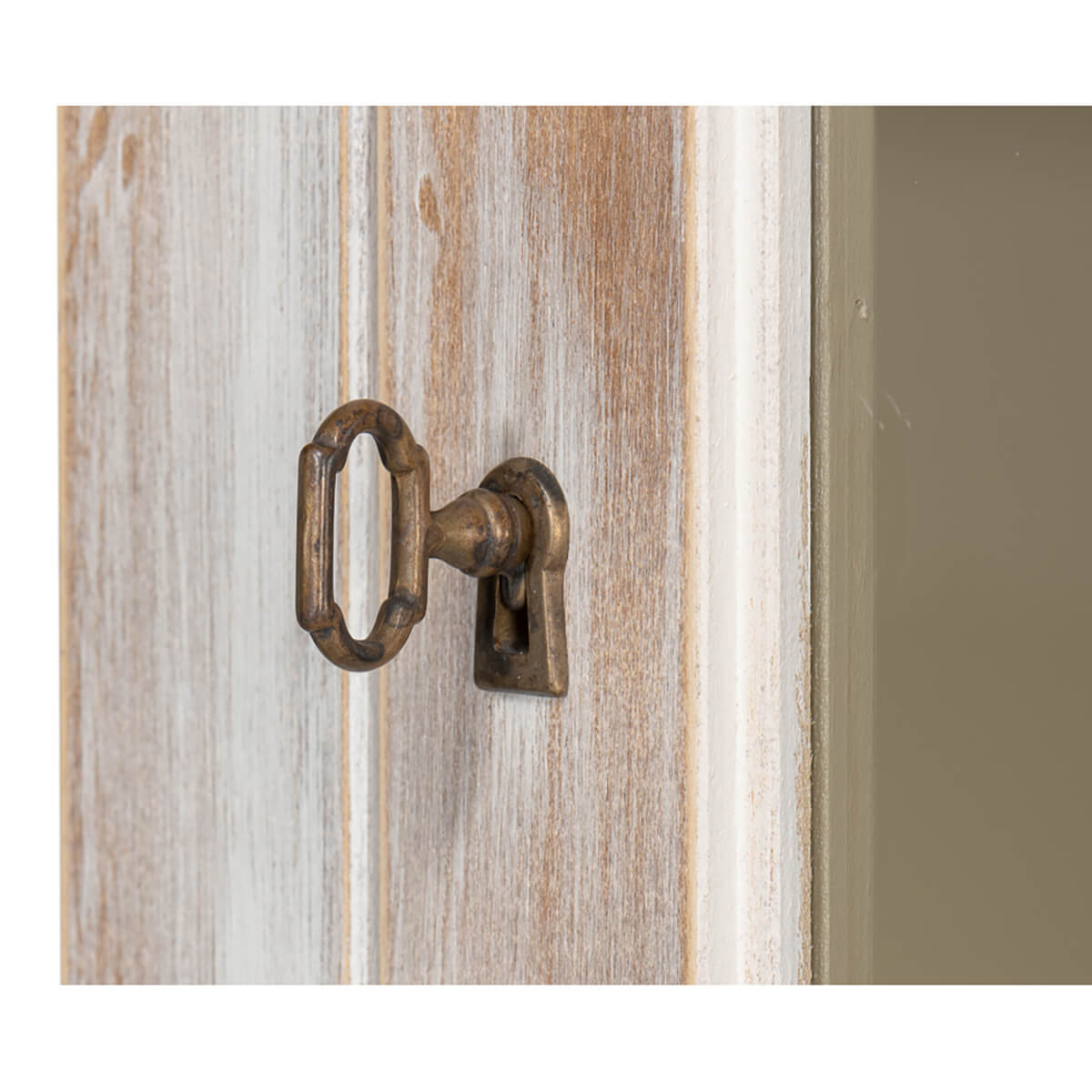 Close-up of hutch keyhole in distressed wood.