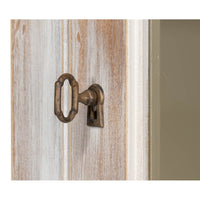 Close-up of hutch keyhole in distressed wood.