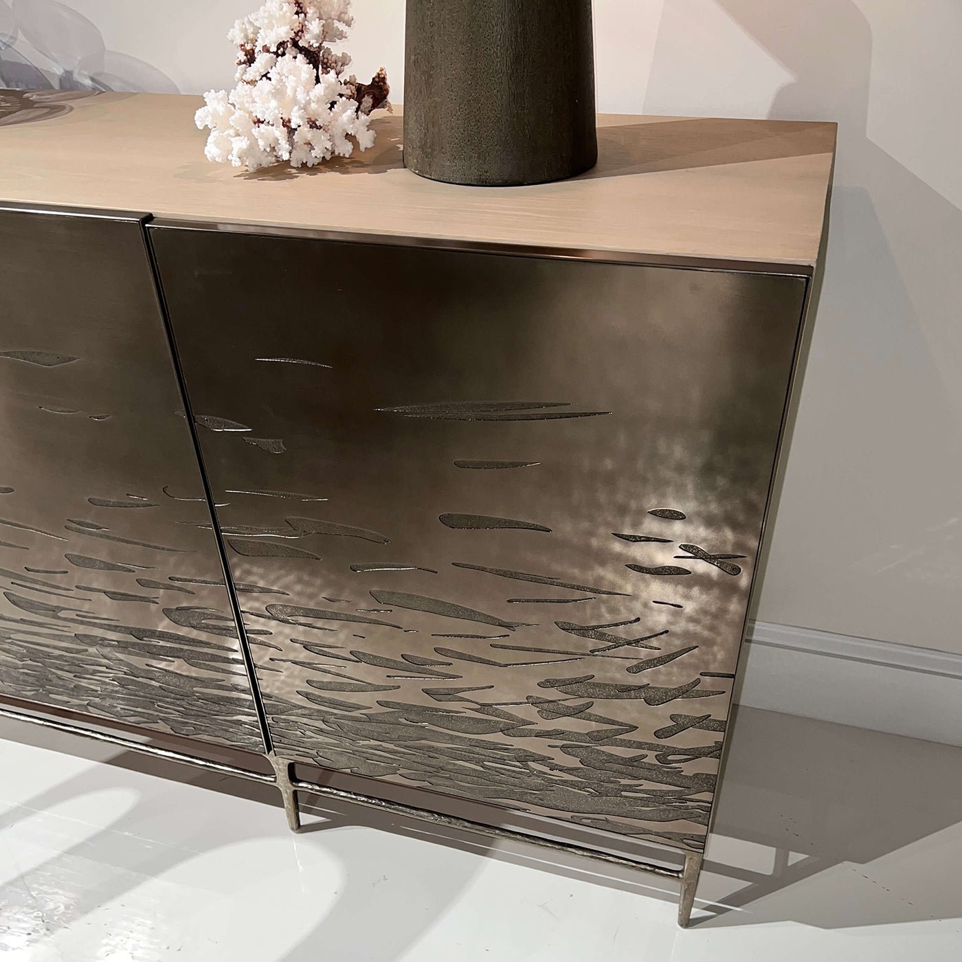 Close-up of cabinet doors with brass etching