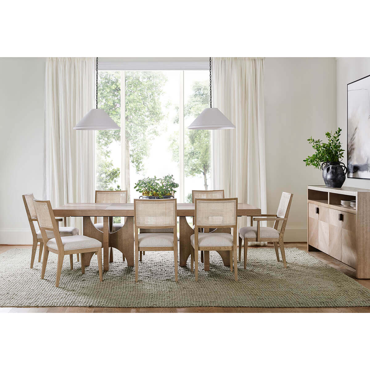 Light ash dining table in dining room setting.
