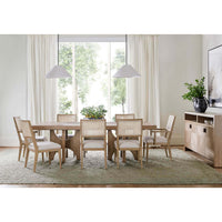 Light ash dining table in dining room setting.