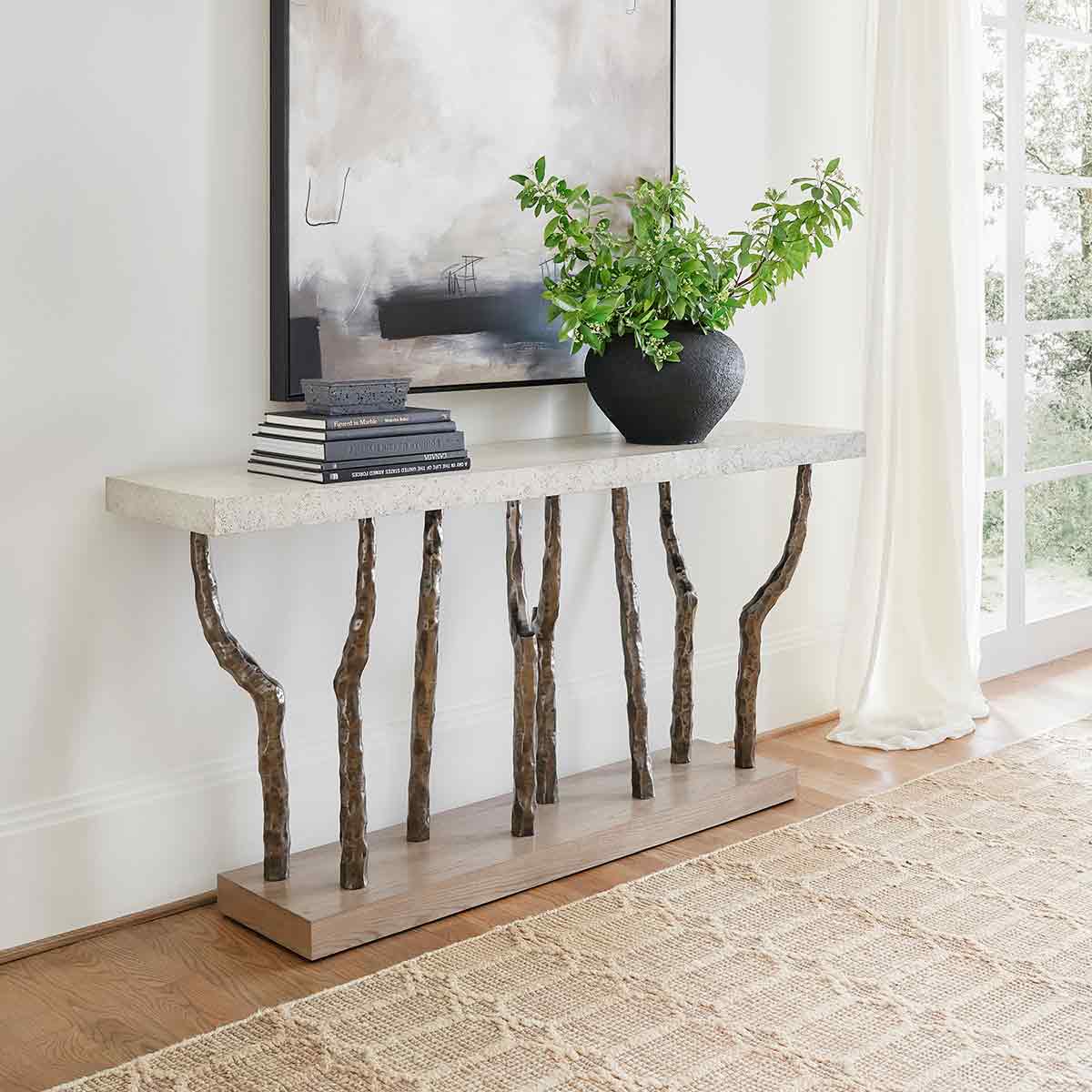 Decorated console table in a stylish living room setting.