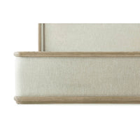 Close-up of footboard detail on the framed bed.