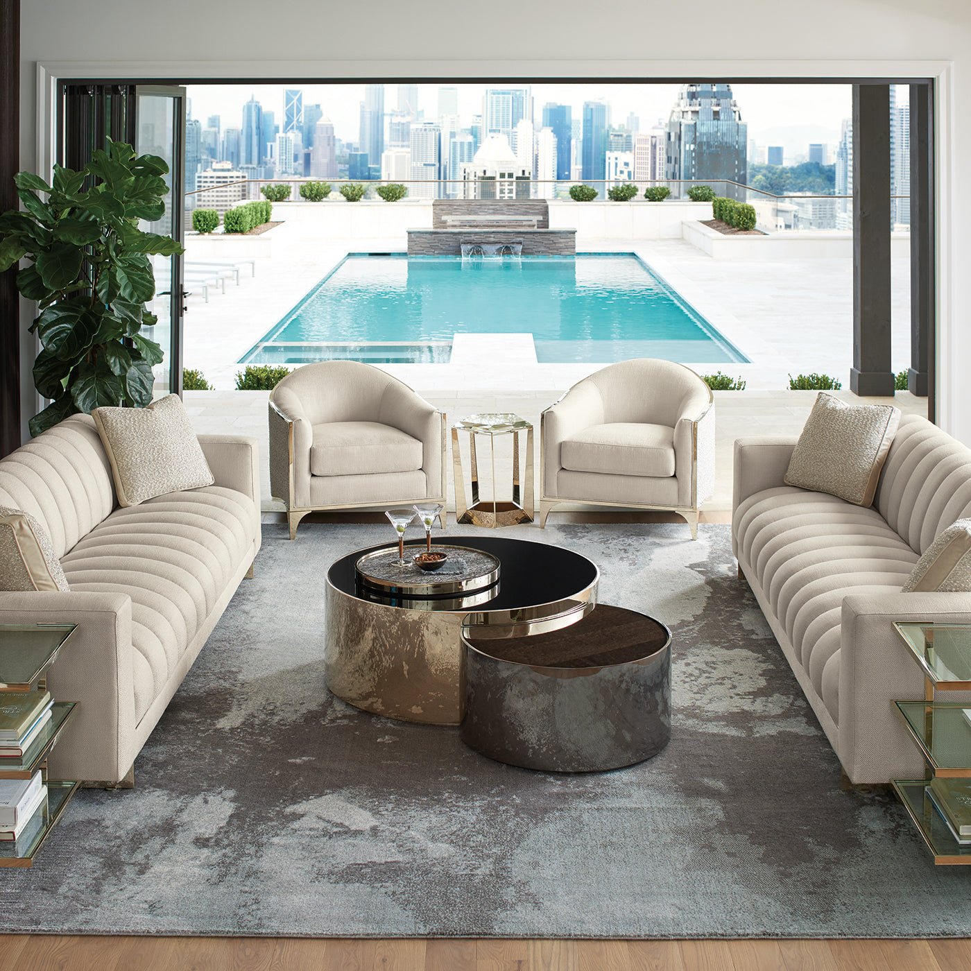Modern living room with accent table, sofas, and pool view.
