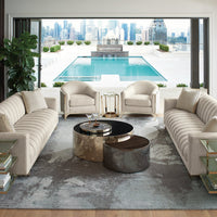 Modern living room with accent table, sofas, and pool view.