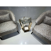 Accent table with chairs on glossy white floor.