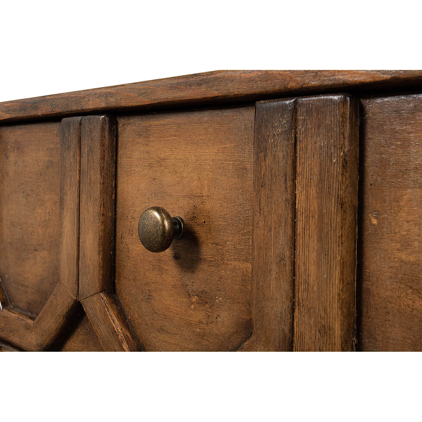 Close-up of sideboard knob and geometric detail.